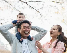 kid on dads shoulders with mom