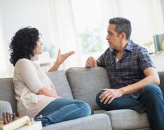 couple sitting on couch discussing something