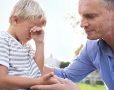 man helping son cope
