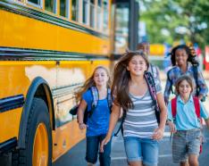 teens beside school bus