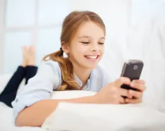 Young teen girl looking at mobile device