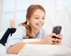 Young teen girl looking at mobile device