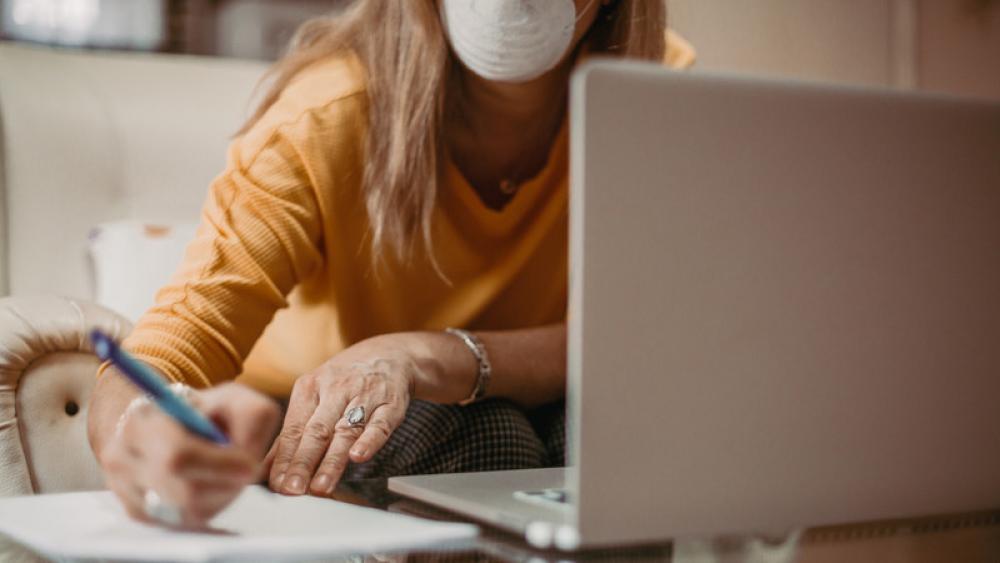 worker with mask at computer