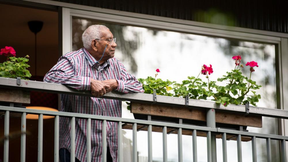 man looking over balcony