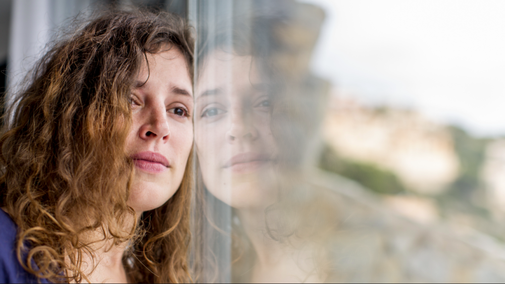 Woman leaning against window 