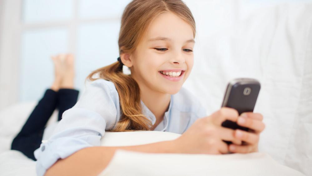 Young teen girl looking at mobile device