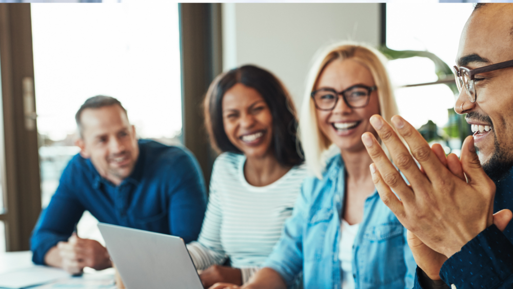 4 employees smiling