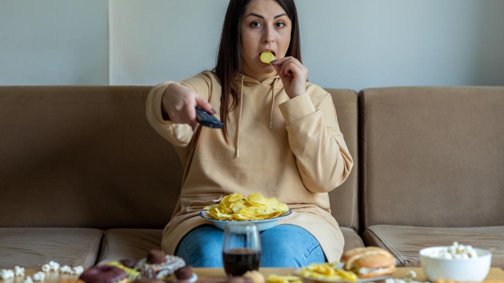 Woman eating potato chip